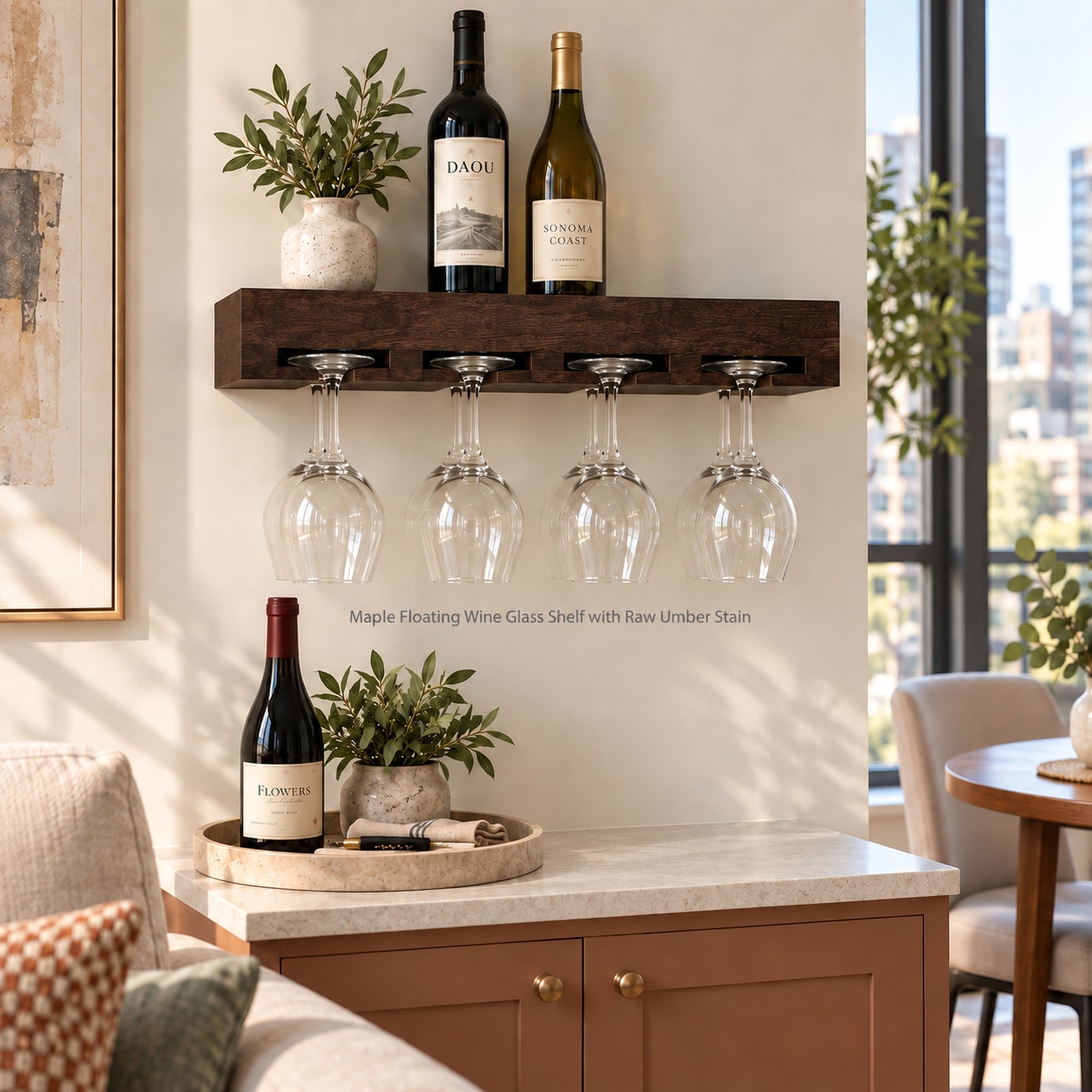 A floating wall-mounted wine glass holder shelf in a warm dark brown raw-umber finish, shown in a styled living room setting. The shelf holds two wine bottles and small potted green plants, with eight clear wine glasses hanging from the integrated glass holders below.