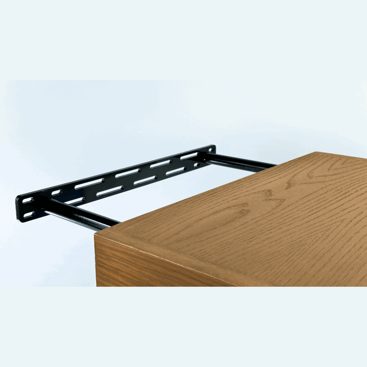 black metal bracket that a floating shelf mounts onto